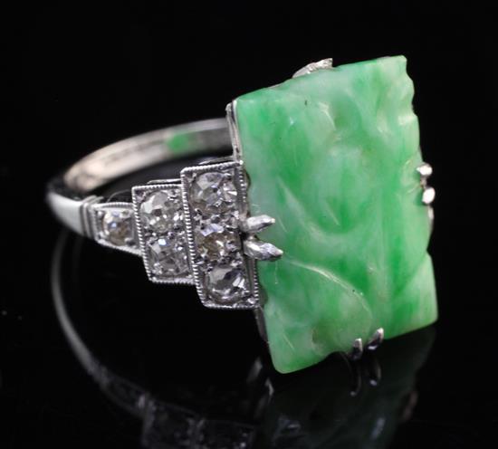 A mid 20th century 18ct white gold and platinum diamond and jadeite ring, size M.